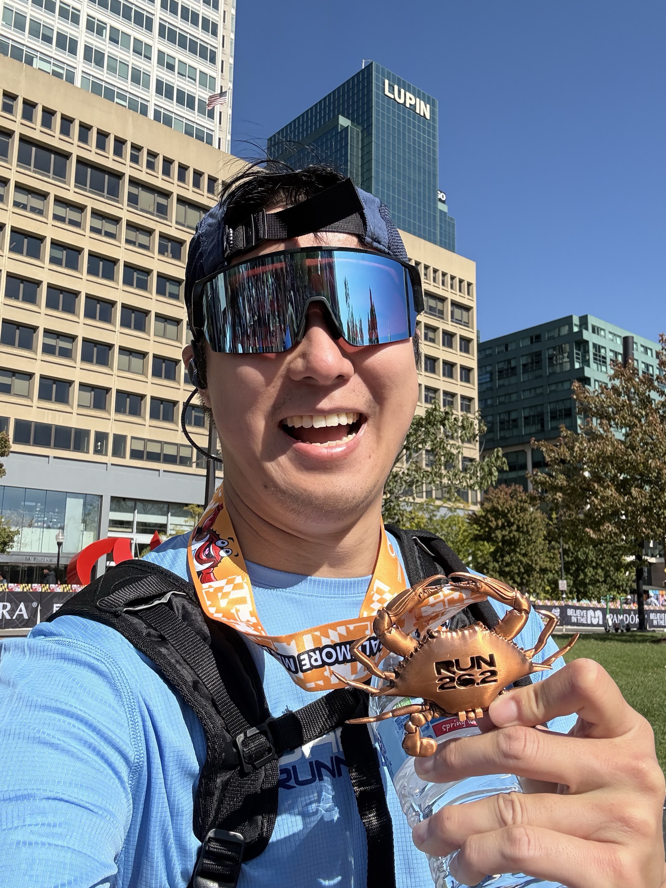 Kevin Lan after a race, holding a finisher's medal